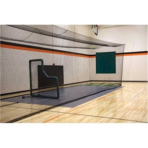 Image of A black batting cage with a green background, featuring a large net and a small wooden structure with a red object on top.